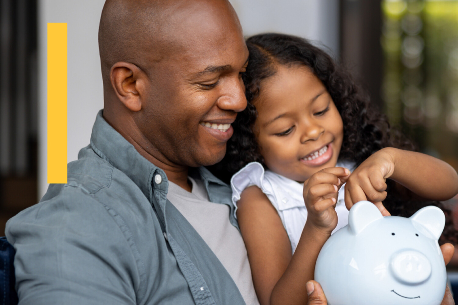 A father and daughter counting change with a piggy bank
