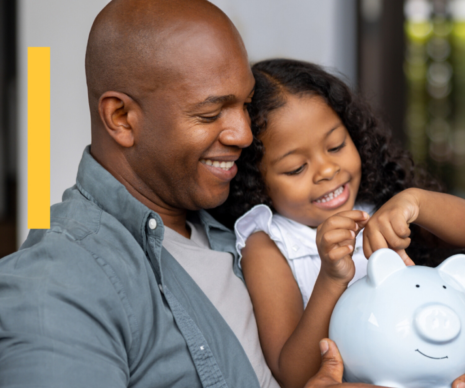 A father and daughter counting change with a piggy bank